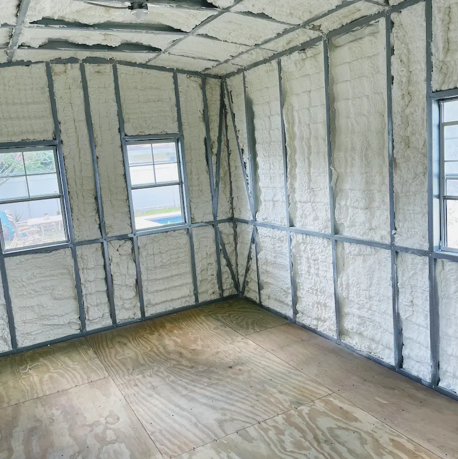 Closed-cell spray foam insulation applied to wall cavities in a residential project in Center